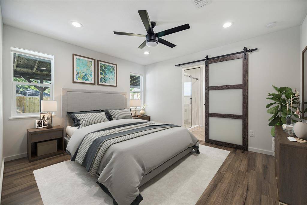 Primary bedroom with new double paned windows designed perfectly to accommodates a king bed between them.