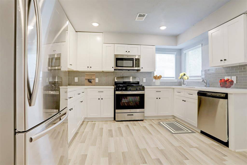 Open concept kitchen with marble countertops.