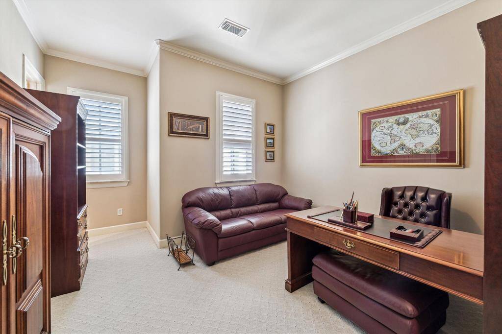 Bedroom Three on Level Three with carpet, crown molding and en-suite bathroom, currently used as an office.