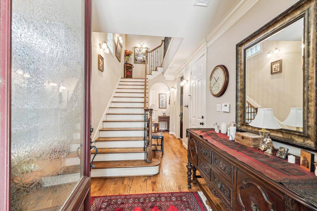 A welcoming entry with high ceiling and hardwood flooring.