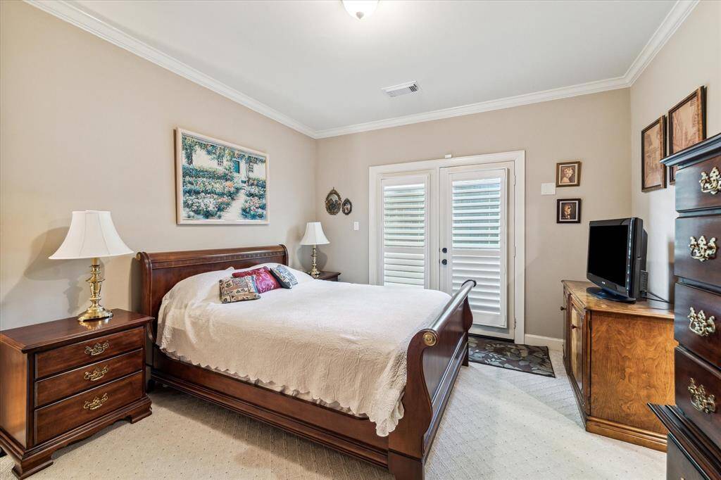 Secondary Bedroom one on Level One with en-suite bathroom and rear patio access.