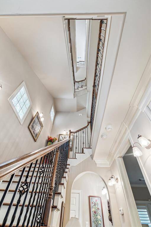 A view from the main floor of 4812 Austin looking up the four levels of the handsome staircase. Please note an elevator shaft is also present.