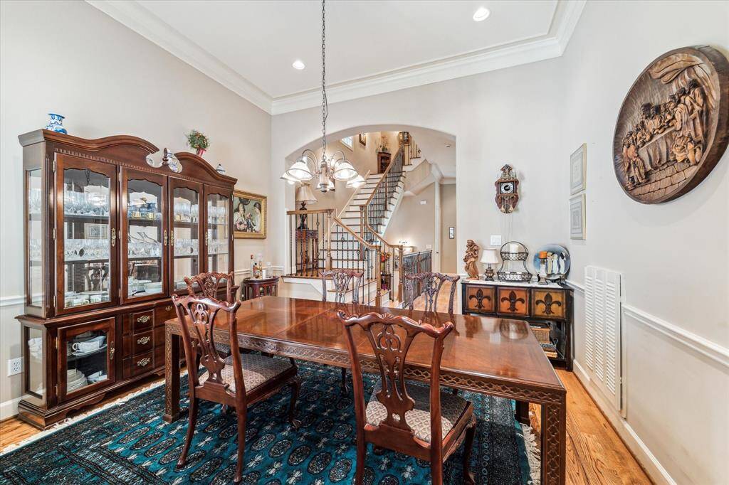 Dining Room off of the Kitchen with Hardwood flooring, crown molding and wainscoting, recessed lighting and chandelier.