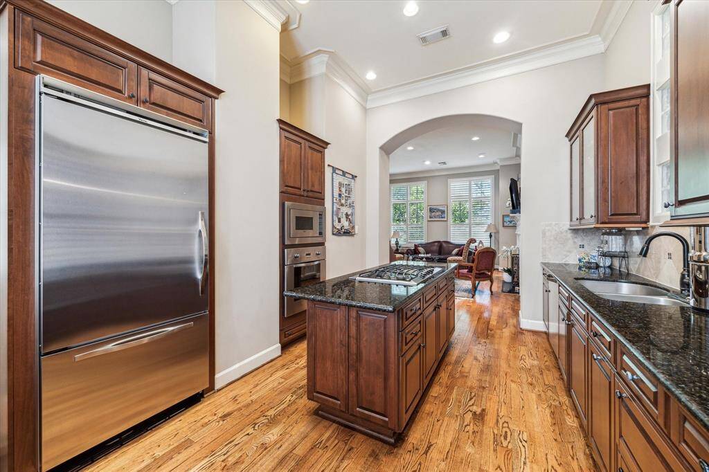 Island Kitchen and Breakfast Nook open to the Living Room with quality stainless appliances, hardwood flooring and recessed lighting.