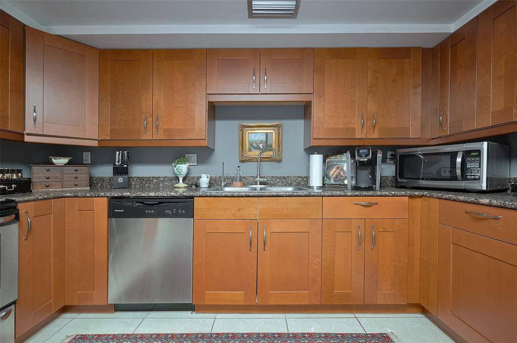 The space is accented with a decorative rug and offers ample storage and counter space.