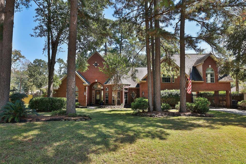 Located on a quiet street shaded under towering trees with manicured gardens, front yard sprinkler system, gated drive leading through the portecache to a 3 garage with additional rear parking, perfect for boat, rv or additional vehicles.