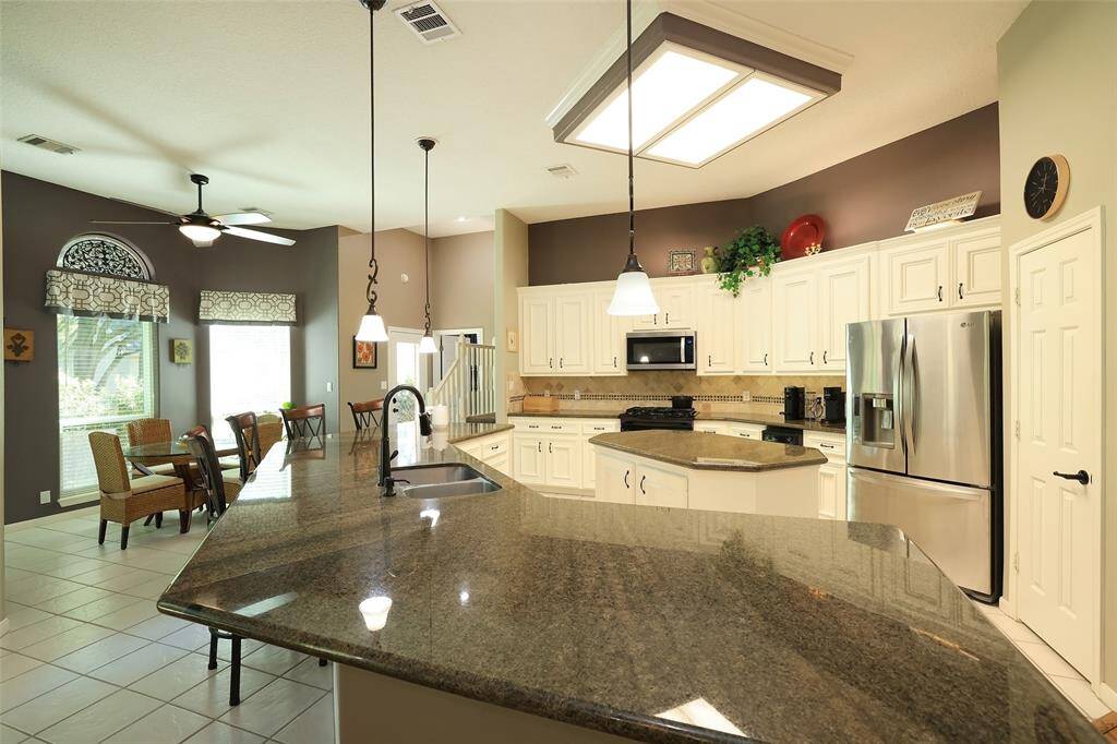 Kitchen features above cabinet and under cabinet lighting.