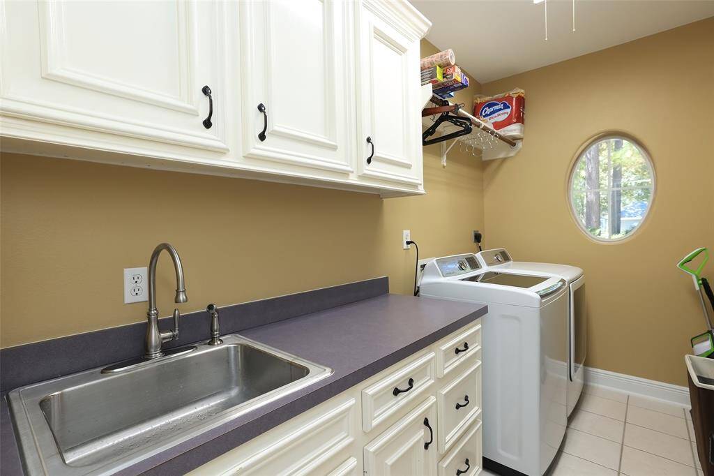 Utility room is spacious with sink,plenty of counter  and cabinets.