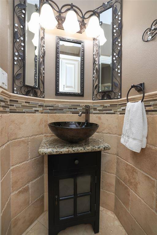 The half bath has lovely cabinet and vessel sink.