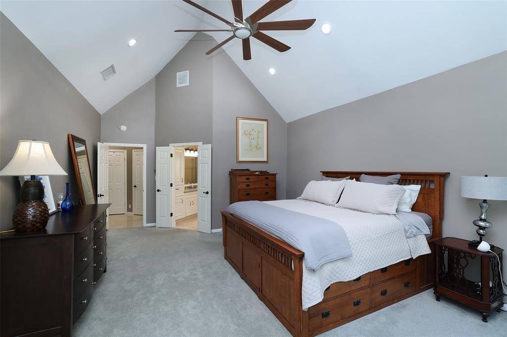 Another view of the master bedroom with high ceilings and recessed lighting.