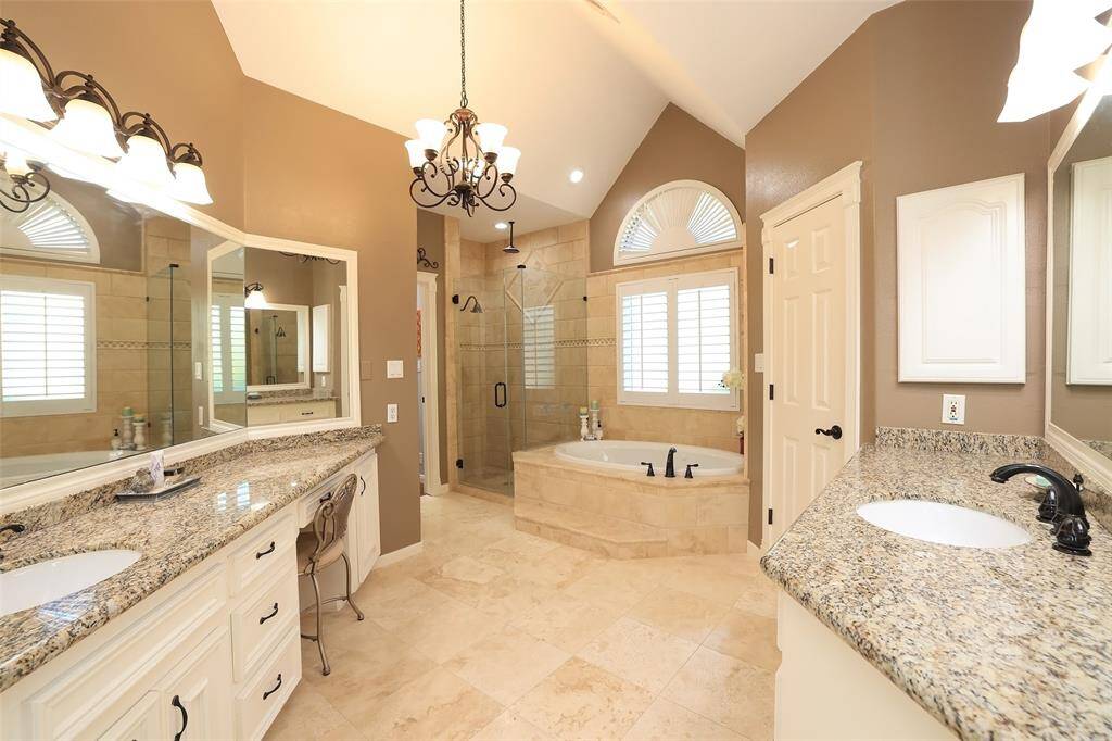 Just Fabulous Master Bath! Travertine floors, tumbled marble tile shower and tub surround as well as his and her sinks with granite counters.