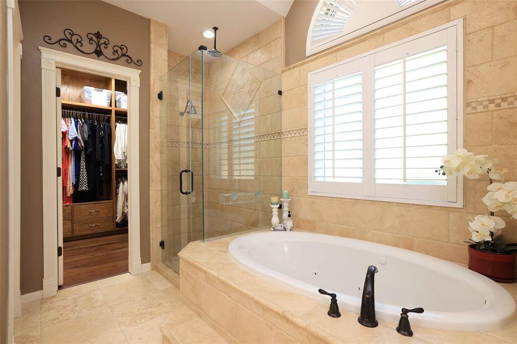 Master bath has His and Her closets that have been completely updated with custom door molding, custom hanger space and soft close drawers.