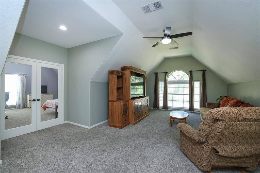 Upstairs is this enormous gameroom with 2 walk-in Texas Basements for great storage.