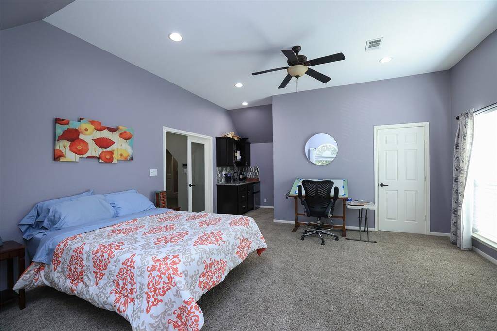 Another view of the upstairs bedroom which could be used as a 2nd office, entertaining space. Wet bar has sink and beverage refrigerator.