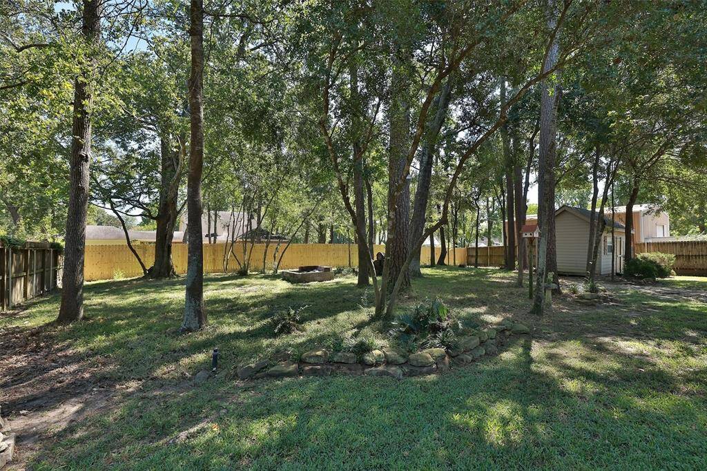 Another view of the backyard and new fence put in just recently. There is a bricked small fire pit in back, great for fall evenings outdoors. Aerobic Septic waters most of this back area.