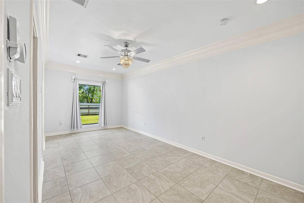 The owner’s suite offers elegance and serenity with crown molding, recessed lighting, and a chandelier fan, plus a spa-like bath with a jetted tub, separate shower, and his-and-hers custom vanities.