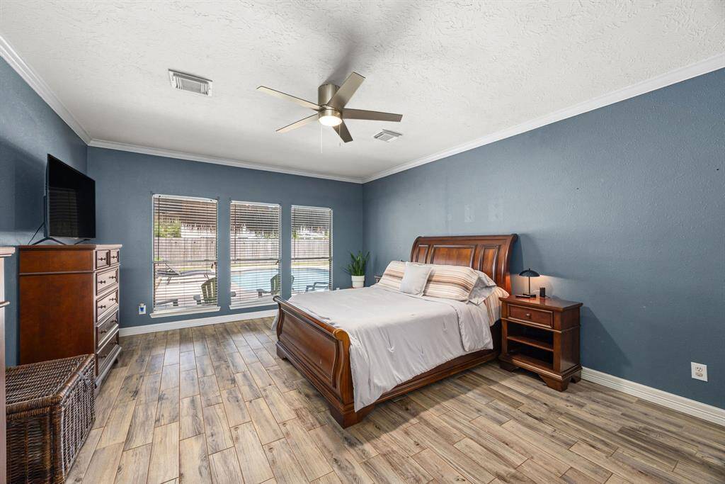 Huge primary bedroom with view of pool.