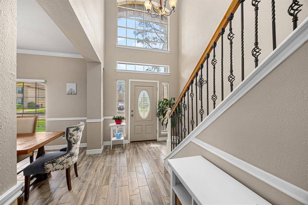 Entry opens to soaring ceiling and beautiful staircase.