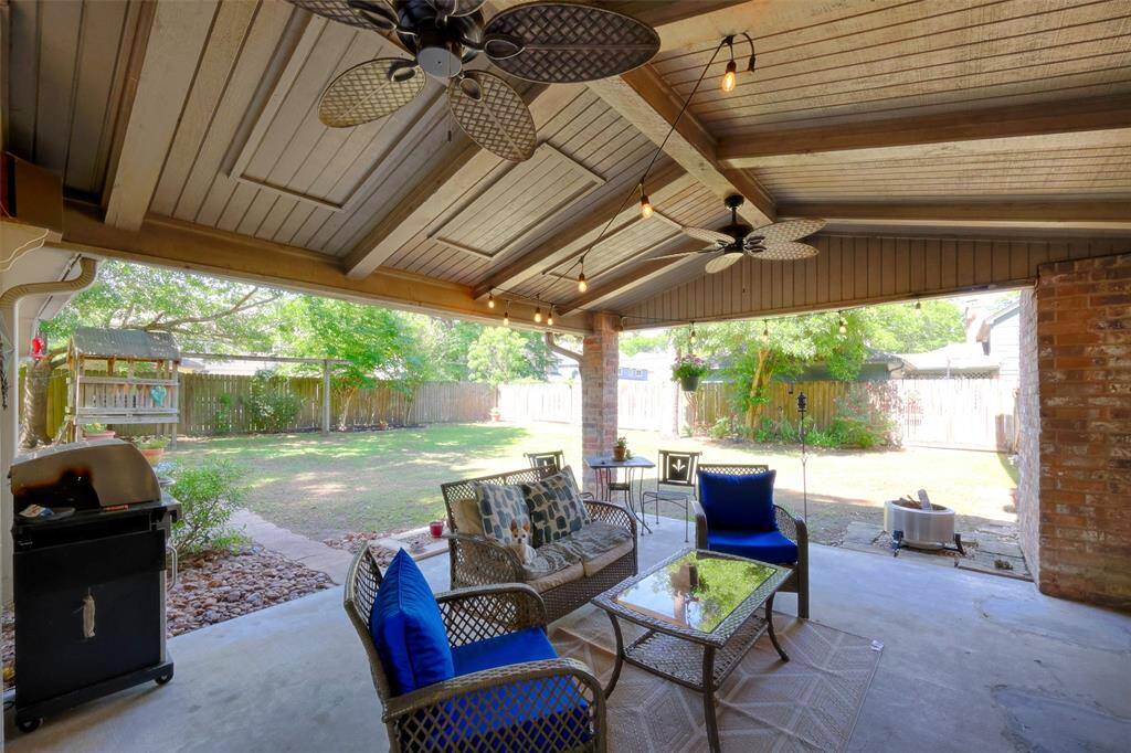 Covered Back Patio, where plenty of time is spent enjoying the outdoors, watching a game on the mounted tv, or cooking on the grill.