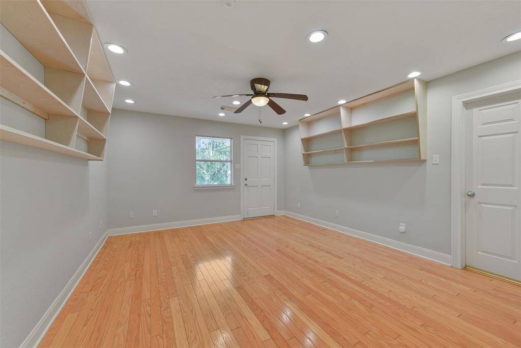 This flexible-use space is secluded off of the kitchen and it could serve as a bedroom, craft room, exercise room, or whatever you dream of. It offers interior, exterior, & garage access doors, wood floors, a wet bar with lockable cabinets, recessed lights, a ceiling fan, and an adjacent bath.