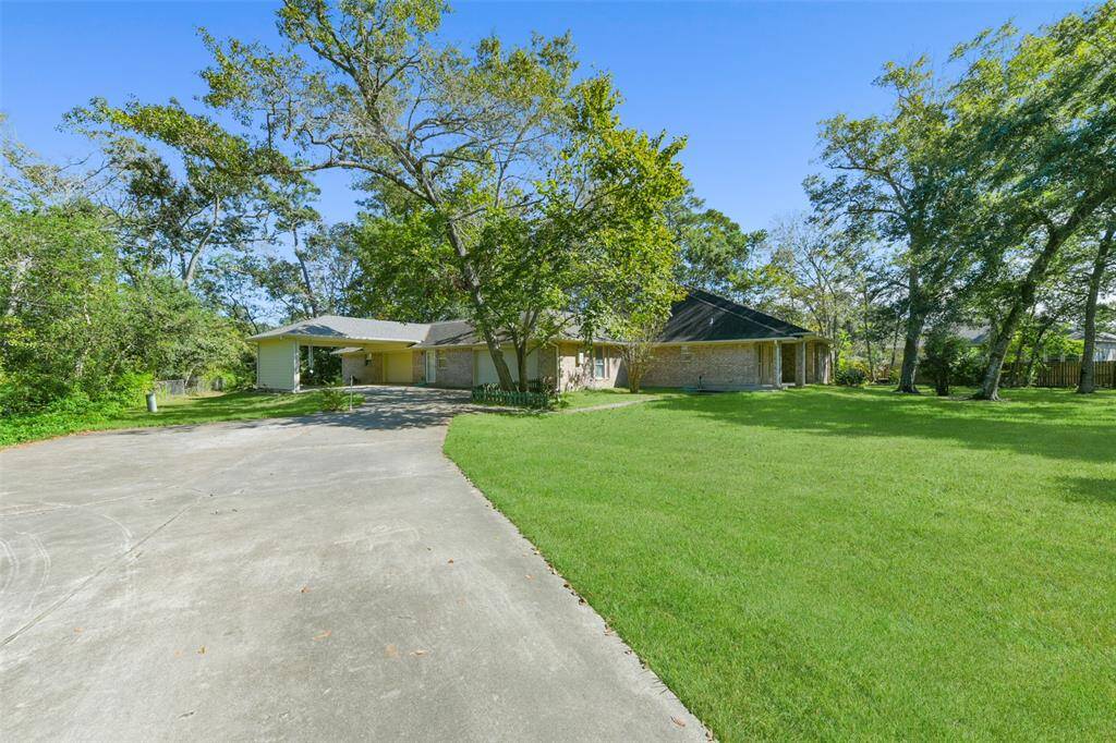 An automatically controlled gated and paved driveway makes its way to the left side of the home where you'll find a 2-car wide port cochere, a 2-car attached garage, and an impressive 34'x30' workshop space with front and back bay doors & plenty of cabinetry.