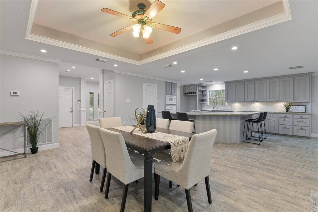 Entertaining guests and serving dinner is a breeze with this elegant dining space at the heart of the home. The wrap-around breakfast bar in the kitchen allows for additional seating or serving space to accommodate your needs.