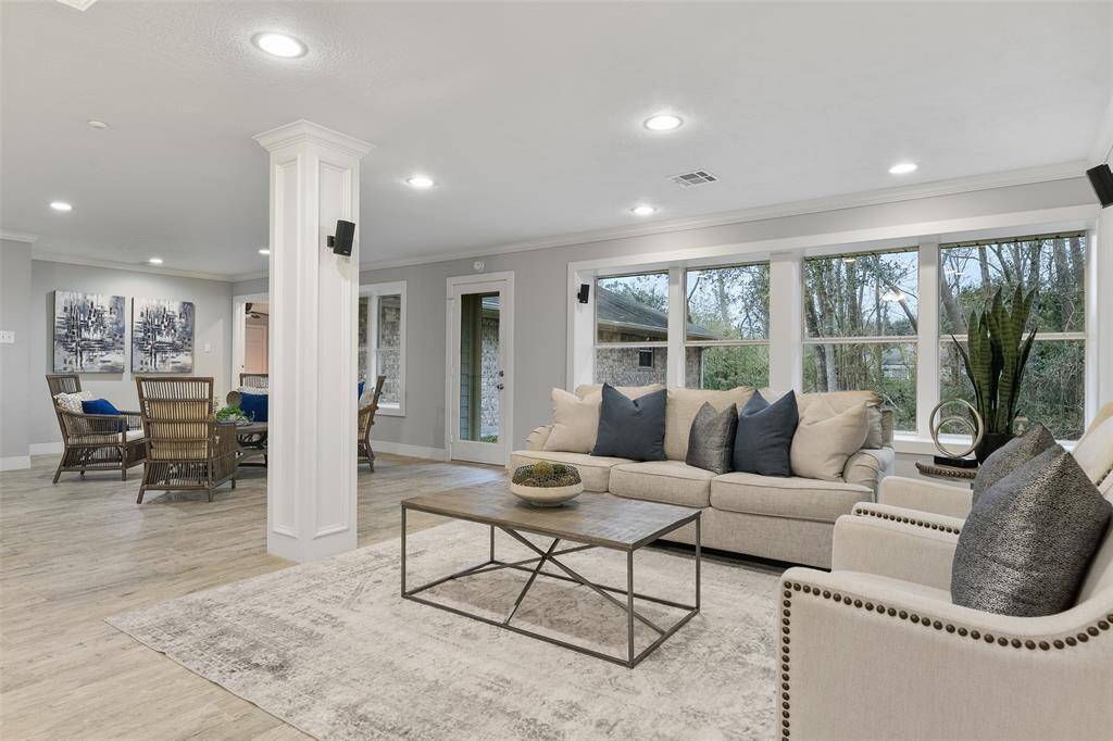 The open-concept design of the living space in this home is ideally suited for entertaining, with seamless transitions among the multiple options of flexible-use gathering spaces. The rear wall of windows creates a peaceful and private setting.