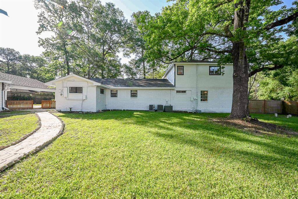 The backyard, behind the house, is perfect for entertainment, large gatherings, and a spacious place for the kids and pets to run and play.