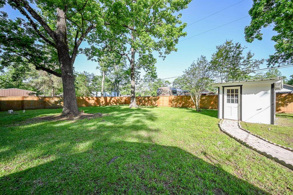 Mature trees provide much needed shade during the warm months.  A brick path leads from the home to the well house.