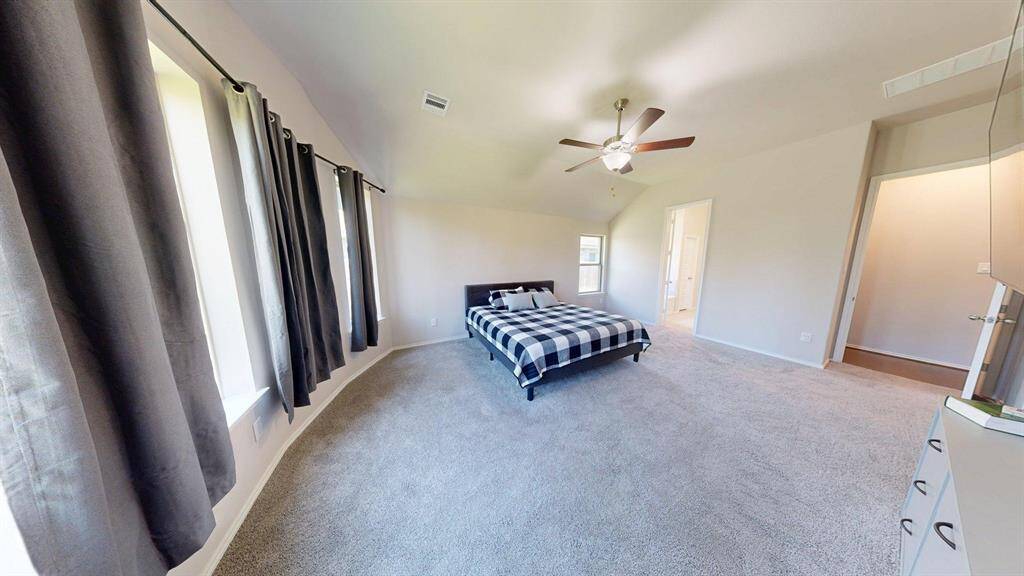 Extra large primary bedroom with vaulted ceilings