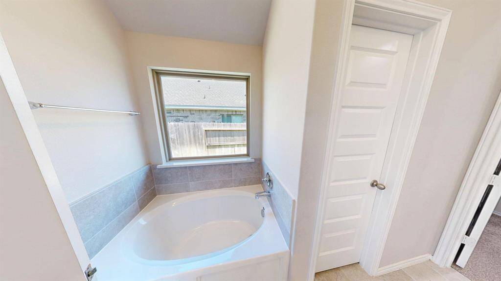 Large size bathtub on the left side, right across the separate shower