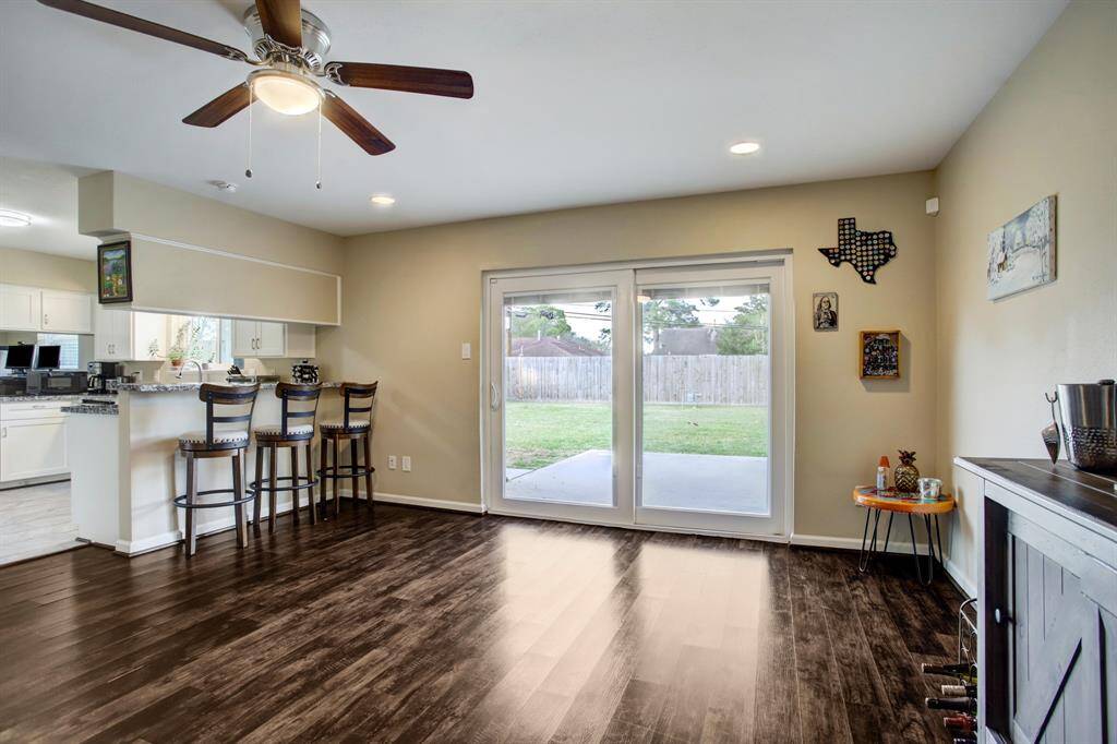 Durable porcelain tile plank floors with wood grain tone!  Custom double-paned sliding glass door to back patio with built-in mini blinds!