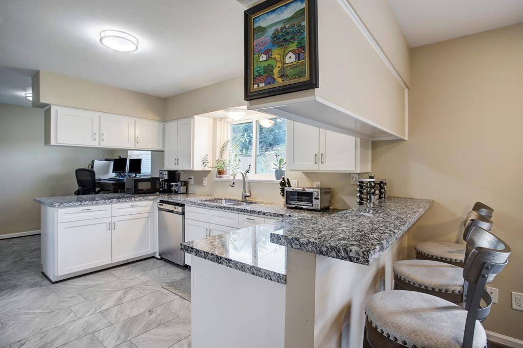 Beautifully remodeled kitchen with granite countertops and tile flooring. Garbage Disposal-2019.