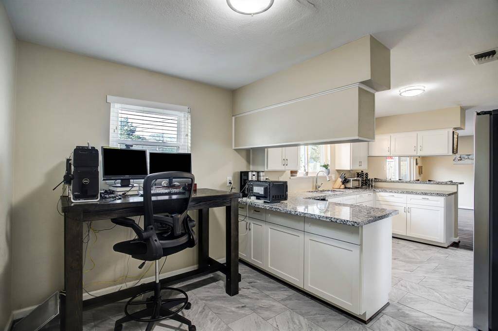 Another view of breakfast and kitchen area. Door to attached garage is located in breakfast area.