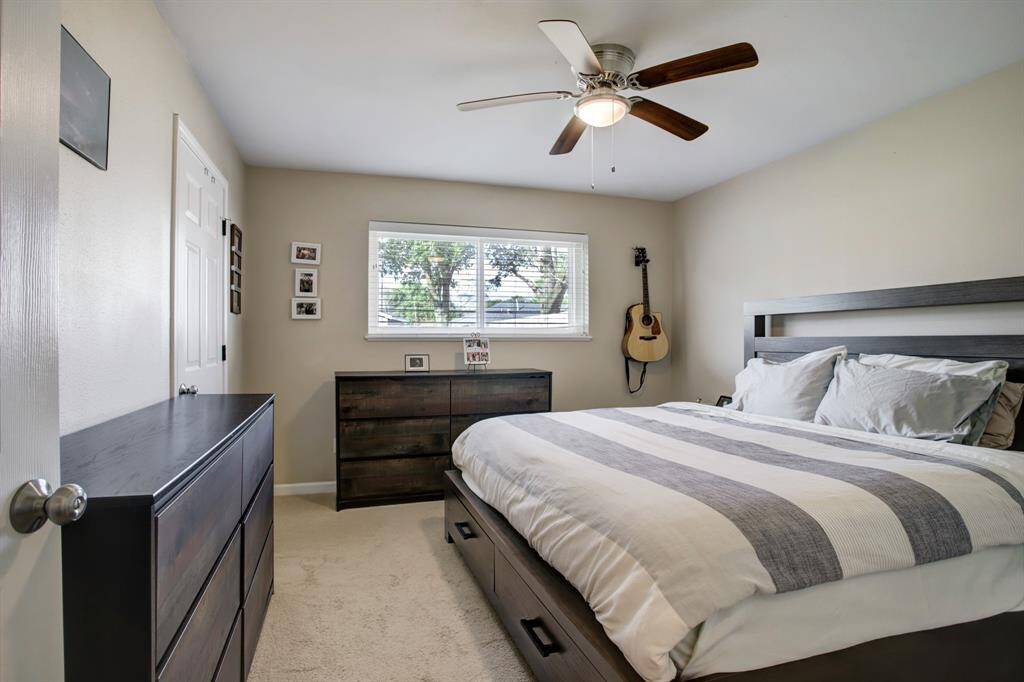Primary bedroom with king sized bed. 2 Closets and ceiling fan! Located in back corner of house.