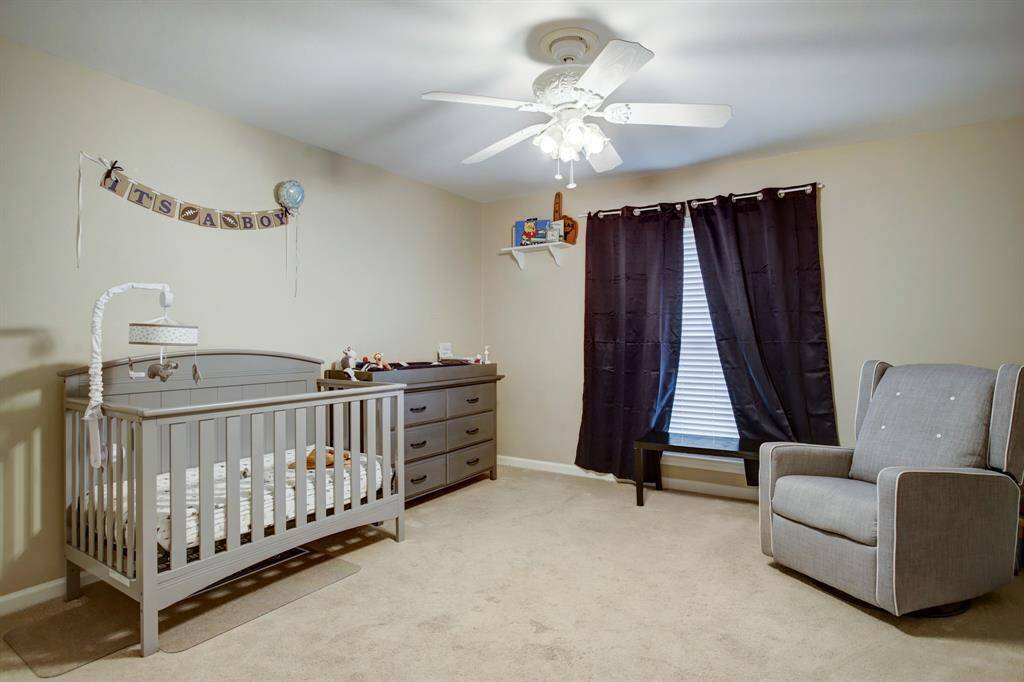 Corner bedroom with floor-to-ceiling window. Ceiling fan and 2 closets!