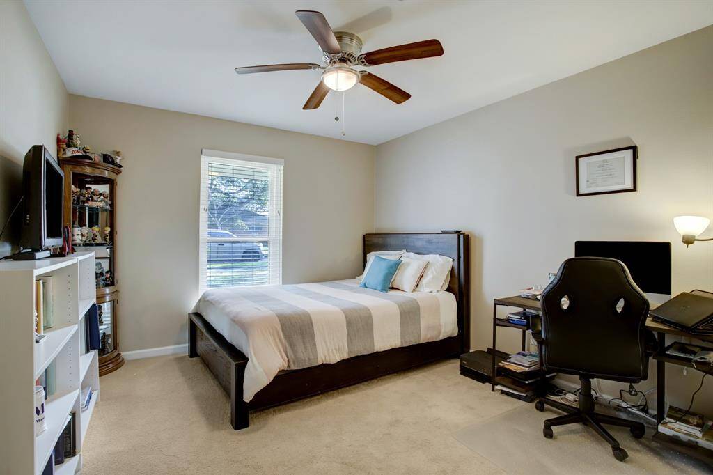 Guest bedroom with ceiling fan and big closet.