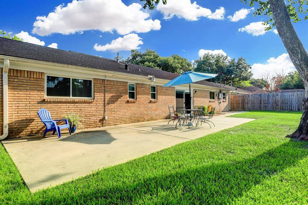 View of large back patio with plenty of room for entertaining. Gutters on back of house.