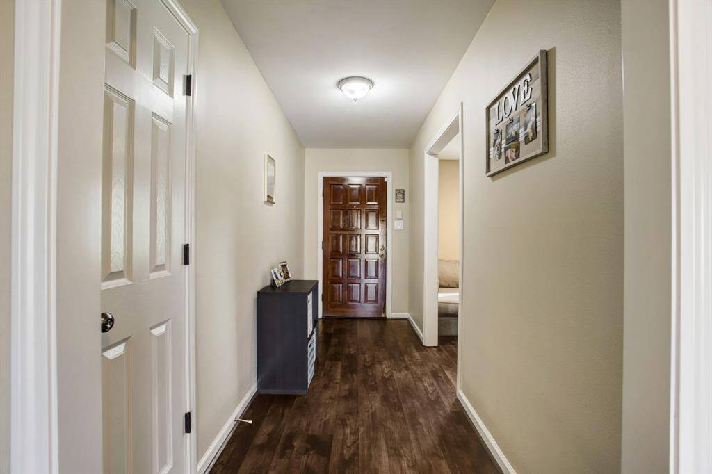Entry foyer with durable porcelain tile plank floors in wood grain tone. Handy coat closet. Raised 6-panel interior doors throughout with brushed nickel hardware.
