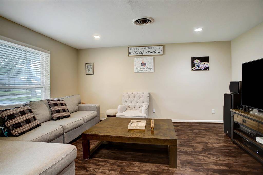 Living room is light and bright with big double-paned window & recessed lights.