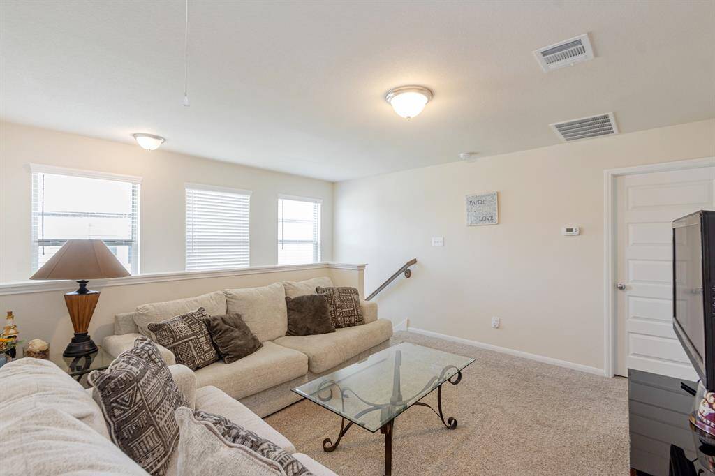 Bright and inviting upstairs loft, perfect for relaxation or entertaining.