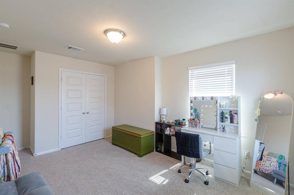 Cozy secondary bedroom with ample natural light, perfect for a guest room or home office.