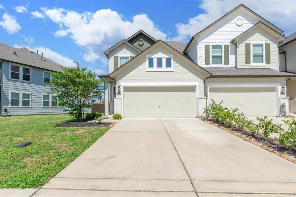 Inviting curb appeal with a spacious long driveway leading to a two-car garage.