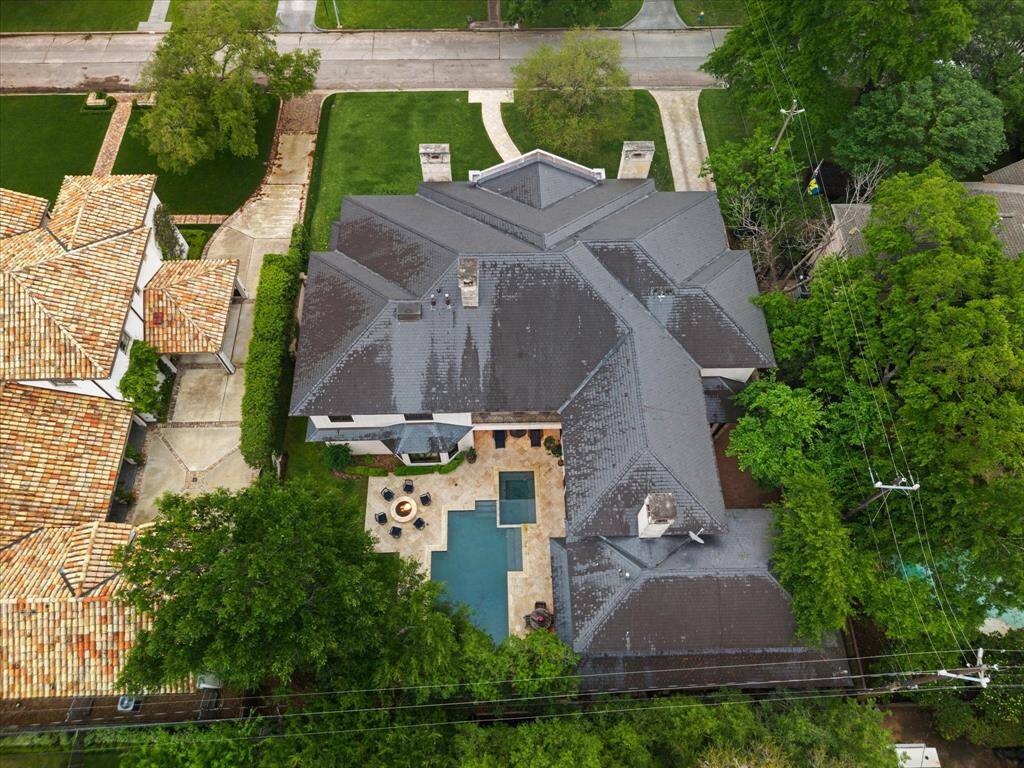 This aerial shot highlights the stunning property situated in charming neighborhood on a tree-lined street. This home promises an elegant lifestyle in a prime location.