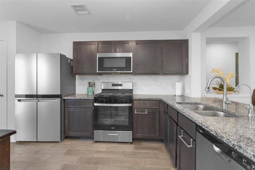 The kitchen also features whirlpool stainless steel appliances!
