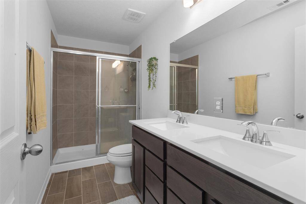 The primary bathroom features double sinks and a large shower!