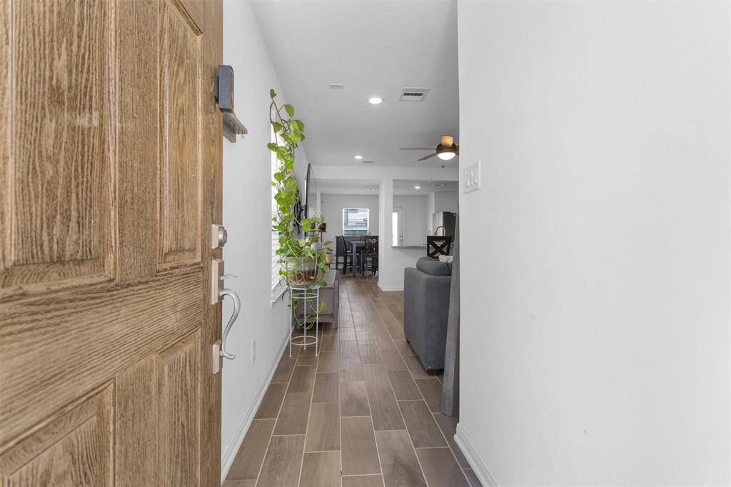 Step inside and be greeted by tall ceilings and beautiful wood-like tile!
