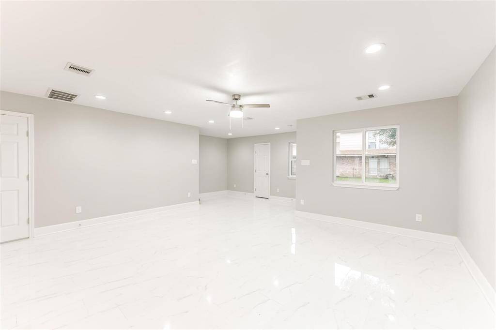 A wide-open living area and dining with bright natural and recess lighting that floods to every corner in the room.