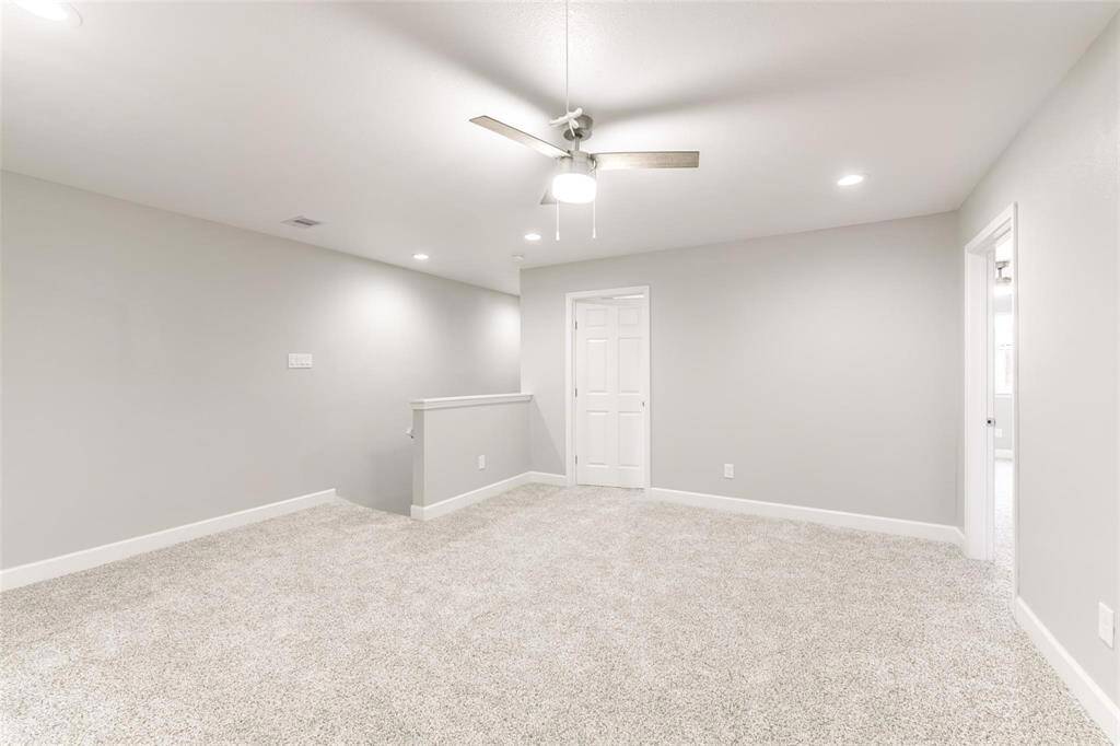 Upstairs living space with new carpet and lighting