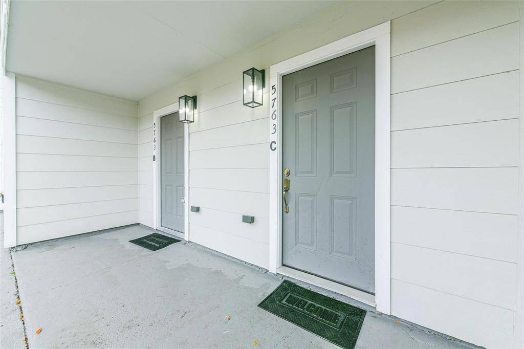 Meet the neighbors! this corner home offers a covered and paved walkway to the entrance with comforting lighting